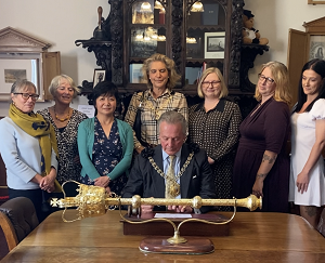 The Mayor signs the accreditation to become a Town of Sanctuary at a special Charter Day celebration to be held at the Town Hall.